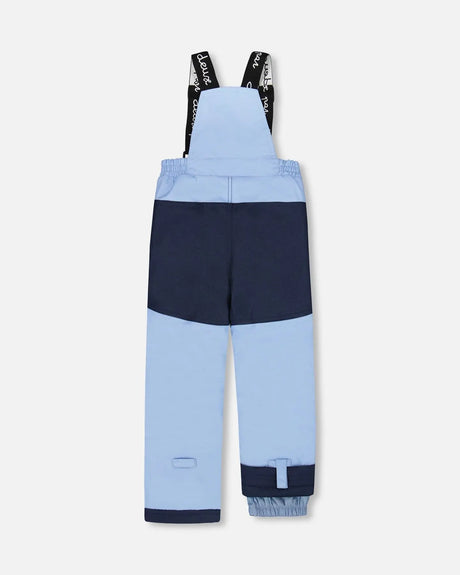 Navy bib pants with Cordura® reinforced panels and ankle snow gaiters.