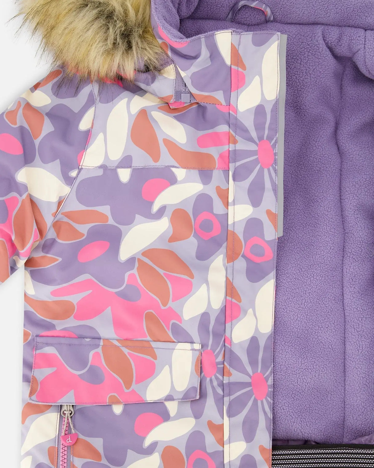 Closeup of printed jacket and purple bib pant waist, Cordura® reinforced.