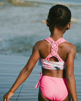Back view of girl in blue flamingo bikini showing triple straps and macramé detail