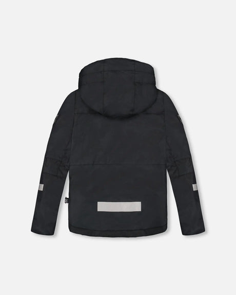 Back view of red and black boys winter jacket with reflective trim