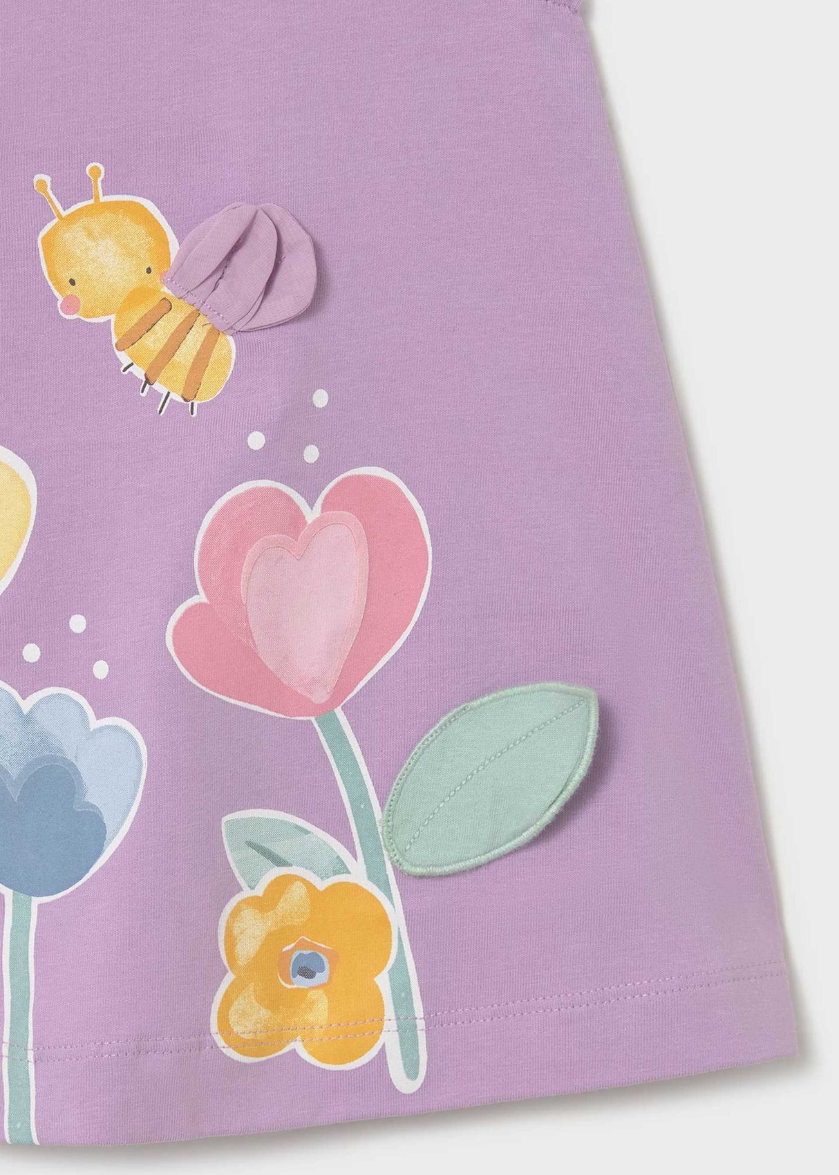 Closeup of floral and bee-inspired screen print on Lilac baby graphic dress.