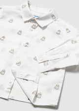 Close-up of the collar, buttons and small dog print on the white shirt