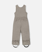 Close-up of bib pants with elastic ankle snow guards and boot straps