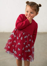 Child wearing the Mayoral red long-sleeve dress with heart-print tulle skirt
