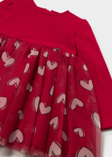 Close-up of the pink heart print on the red tulle skirt and gathered waist seam