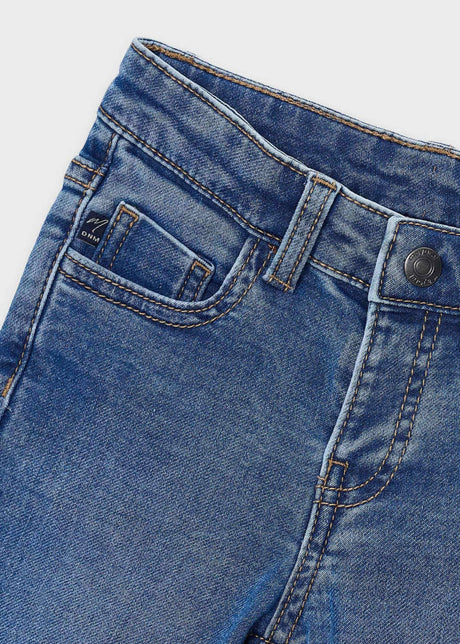 Close-up of the waistband, button and front pocket on the medium wash Mayoral jeans