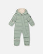 Flat lay front view of the sage green Baby Cloud one-piece snowsuit designed for car seats.