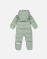 Back view of the sage green infant snowsuit showing horizontal quilting.
