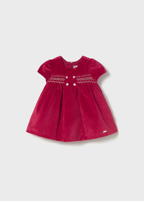 Front view of deep red Mayoral newborn girl velvet dress with smocked bodice