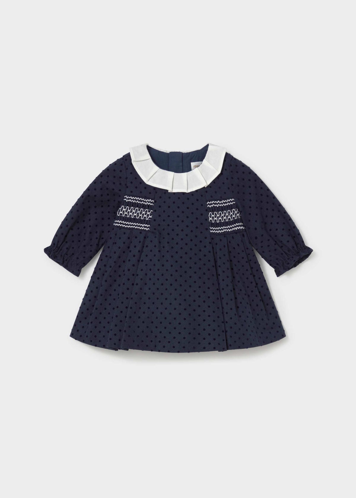 Mayoral baby girl navy polka dot dress with pleated ivory collar and white smocking, front view