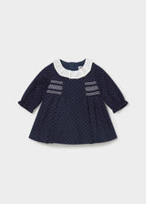 Mayoral baby girl navy polka dot dress with pleated ivory collar and white smocking, front view