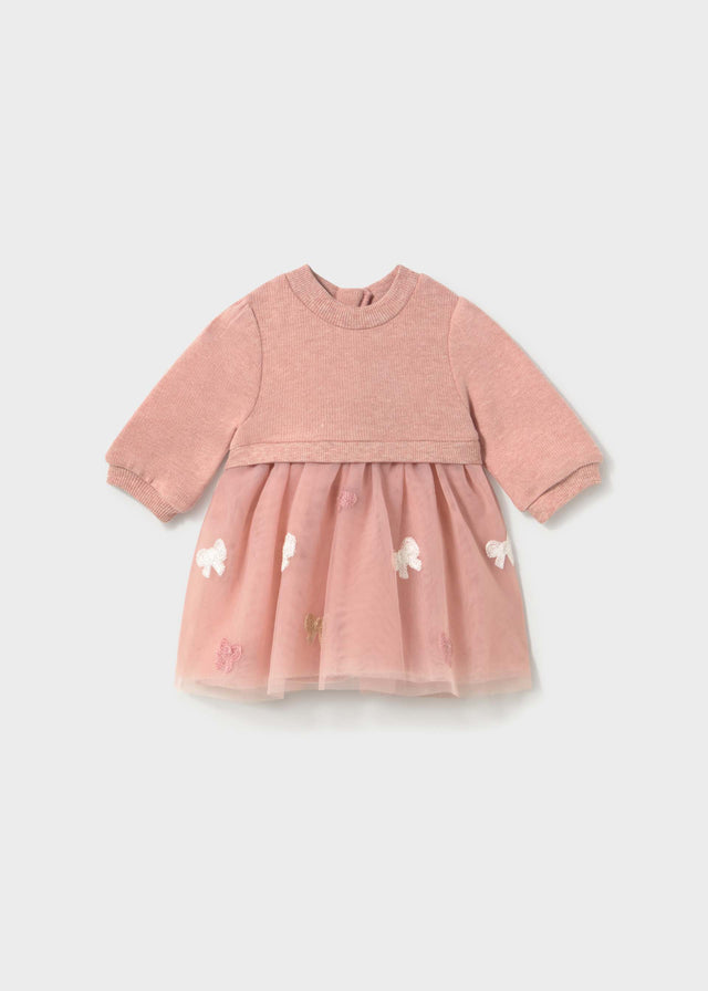 Front view of the dusty pink Mayoral dress with a ribbed bodice and a tulle skirt with bows