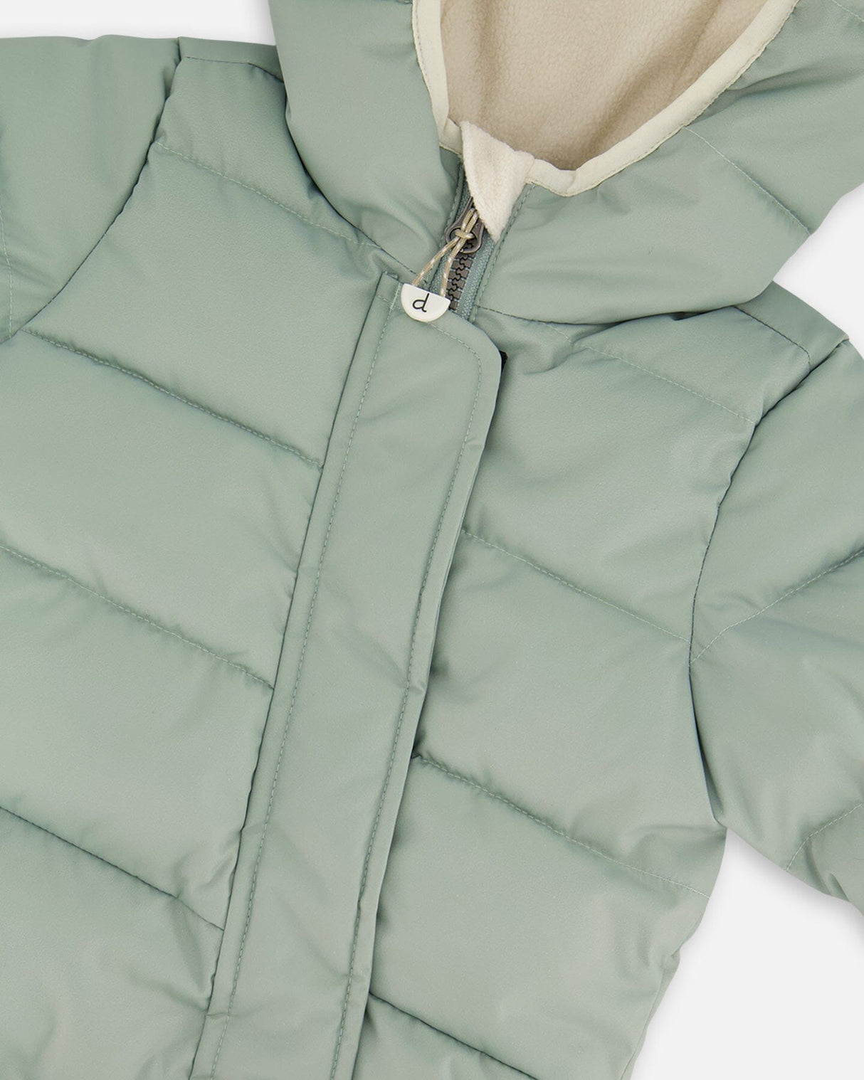 Detail shot of the elastic cuffs and ankles on the sage green car seat–compatible snowsuit